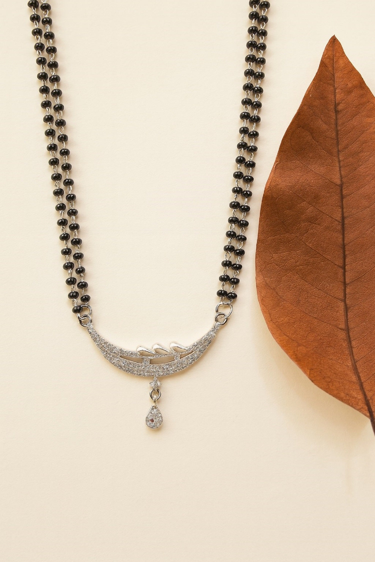 Silver-Plated Double Chain Mangalsutra with CZ Leaf Design & Ruby Drop Pendant – Elegant Daily Wear